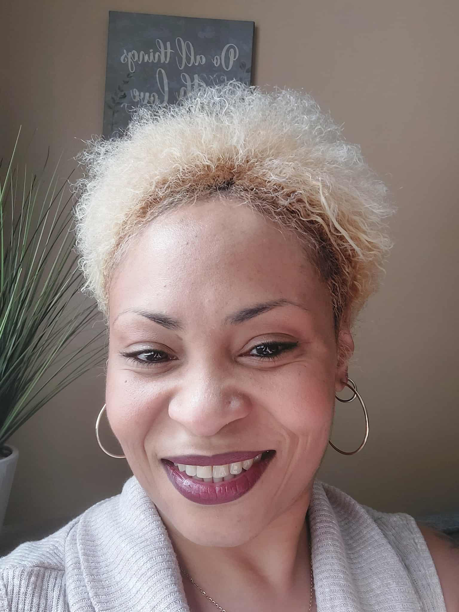 Coach Danielle Jones, a professional and approachable woman in a calm natural setting